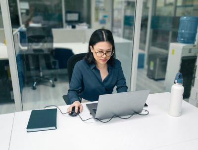 Employee working at her laptop in the office