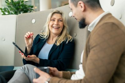 Employees having a chat on a sofa. 