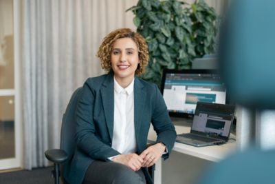 An employee sitting in front of various computer screens. 