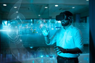 Employee with VR goggles interacting with virtual controls