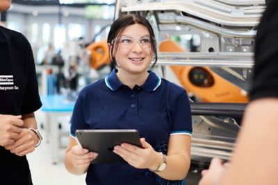 Employees discussing in front of a piece of equipment in the innovation center