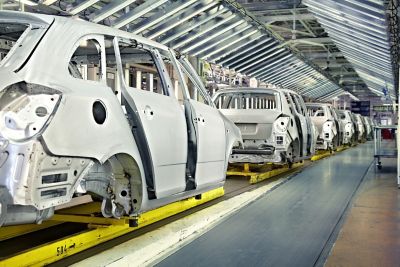 assembled cars in a row at car plant