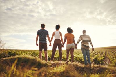 Friends holding hands in the countryside