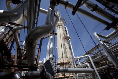 Low angle shot of typical gas processing plant towers and piping