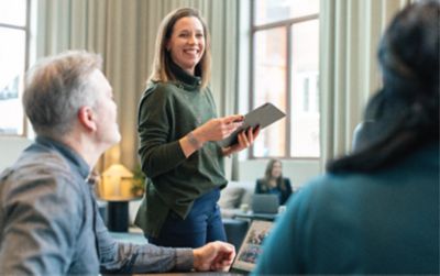 Woman employee presenting in a team meeting