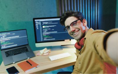 Employee taking a selfie at their coding workstation