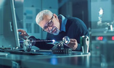 A man working with a laser tool