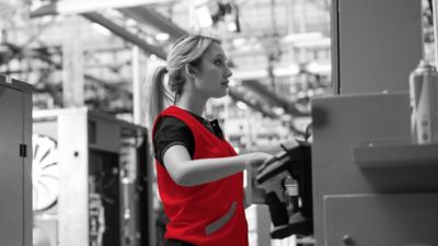 Woman inspecting a machine.