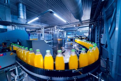 Beverage factory interior. Conveyor with bottles for juice or water. 