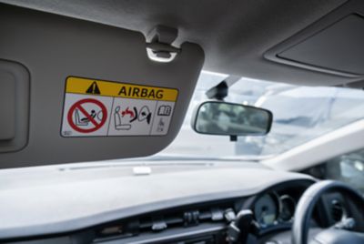 airbag label sticker on a car visor that's down