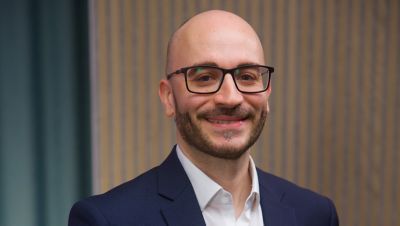 Portrait photo of Marco Mele in white shirt and navy blue blazer. 