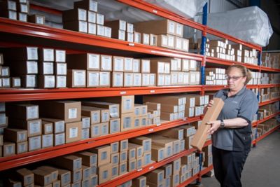 A female nano employee picking parts in the UK warehouse.