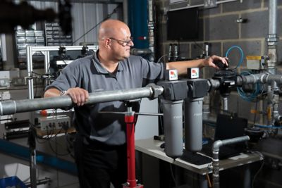 A nano employees assembles two nano filters on a compressed air line