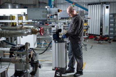 A nano employee works in a warehouse among nano equipment, and is working on a nitrogen generator model