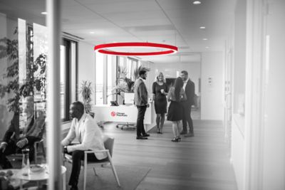 Distant viewpoint of business executives enjoying conversation with colleagues.