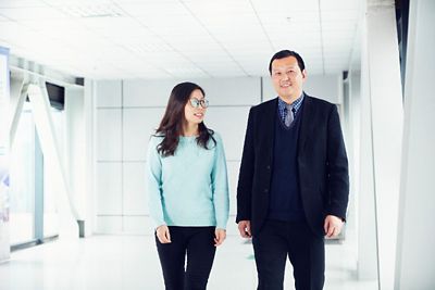 Man and woman standing in an entryway, smiling