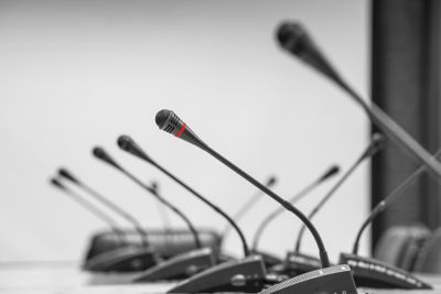 Microphones in front of empty chairs.