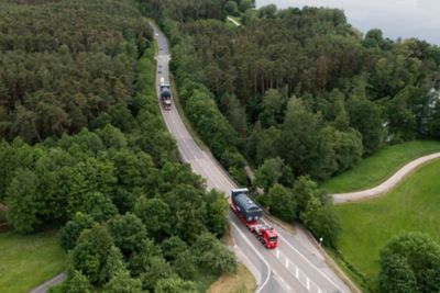 Wide-angle shot of a boiler in transit on a highway, showcasing large-scale equipment delivery.