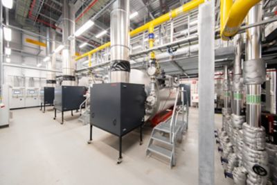 A large industrial boiler room with steam boilers and additional components.