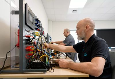 Willebroek Service academy 2 man working