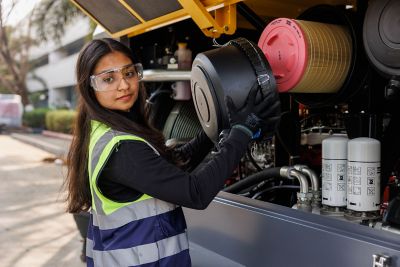 Service technician working on machine.