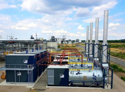 A large industrial facility with multiple steam boilers mounted on a frame and accessories delivering temporary steam for a customer. 
