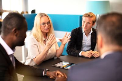 Discussing a solution with colleagues in the office. 