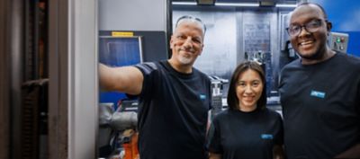 Colleagues smiling and looking at the camera.