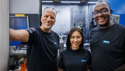 Three colleagues smiling.