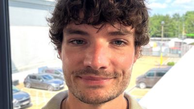 Toby Withers standing in front of an office window.