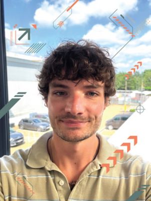 Toby Withers standing in front of an office window.