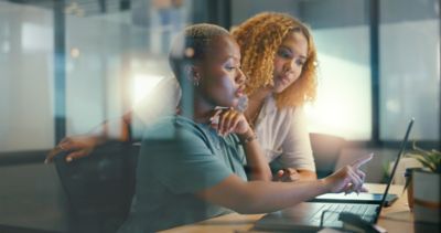 Women reviewing online survey in office
