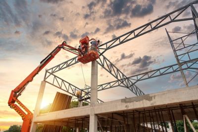 Construction workers working on Construction machine. Aerial platform for workers who work at height on buildings. 