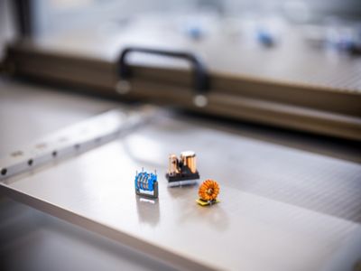 Complex parts like transformers and coils in front of a vacuum chamber