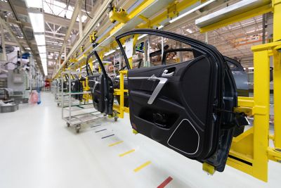 car door on conveyor. Robotic equipment makes Assembly of car. Modern car Assembly at factory 