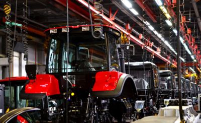 Tractor industry manufacture. New tractors on factory line. Production of agricultural machinery 