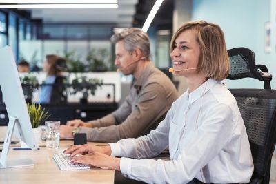 Well being at work : Woman smiling while working
