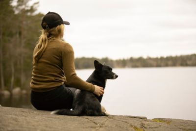 Woman employee with a dog in front of lake