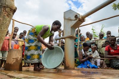 Woman using water well in Malawi